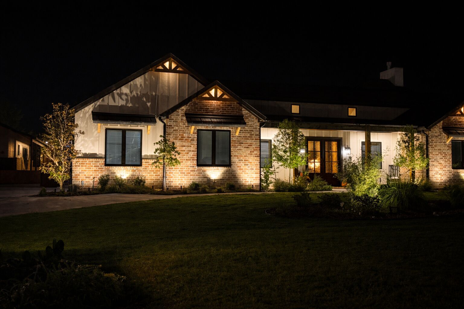 Front entryway with elegant landscape lighting design