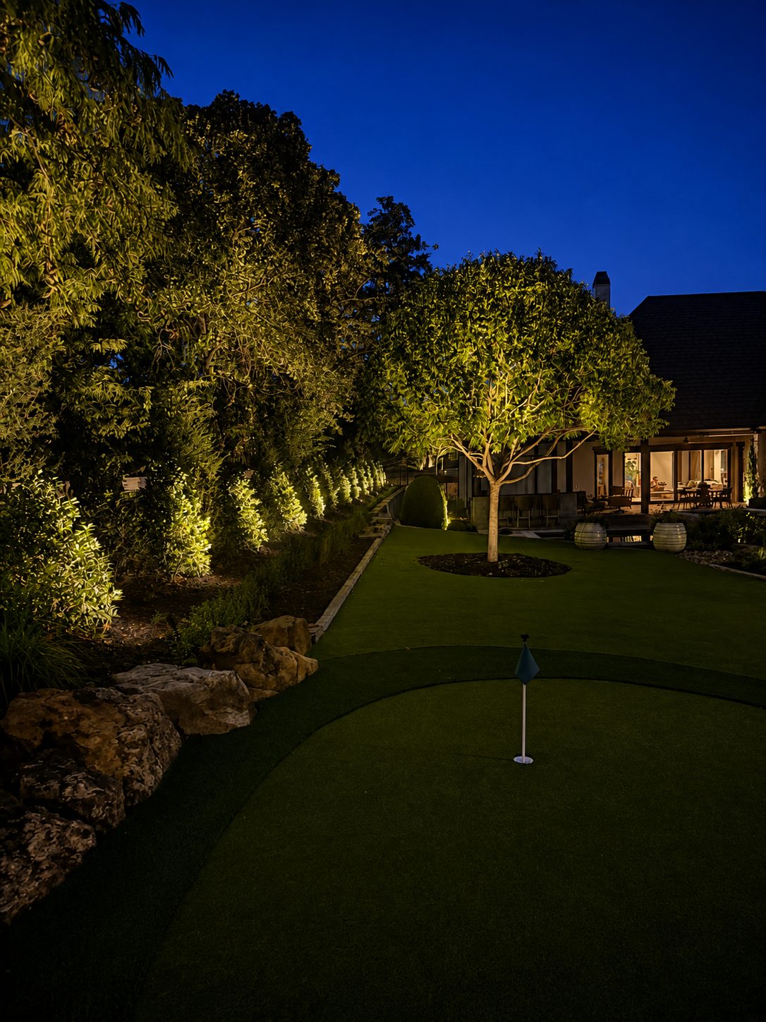 Dramatic tree and entry lighting on a luxury residence